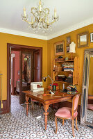 Study with antique desk and ochre-colored walls