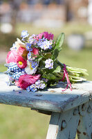 Colorful spring bouquet of bellis, ranunculus, and forget-me-nots