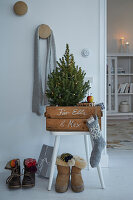 Corner decorated for Christmas with a small Christmas tree and presents