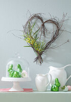 Heart wreath on the wall and green Easter bunnies