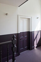 Upper floor hallway with paintwork in dark purple and white