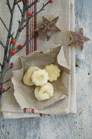Star Anise cookies with holly and wooden stars on dish towel