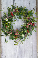 Wreath made of mistletoe, Christmas roses, pernetia, heather and yew tree