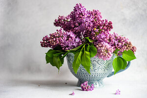 Purple lilac bouquet in a vase