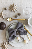 Christmas place setting with napkin decorated with wooden balls