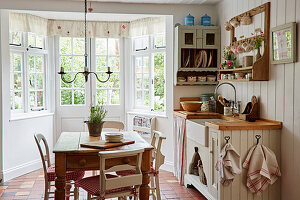 Rustic kitchen and dining area by a bay window