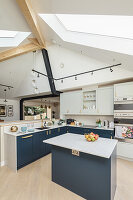 Kitchen island in bright, open kitchen with skylight