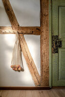 Net bag on old half-timbering next to green door