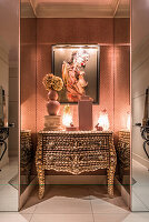 Entrance hall papered with ceramic pot and French shell-covered antique chest