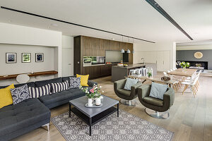 Elegant open-plan living room with seating area, dining area and kitchen