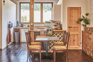 Table with wicker chairs in country kitchen