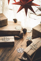 Christmas presents wrapped in wrapping paper with a snowflake motif