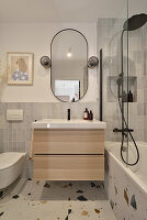 Washstand next to bathtub with backsplash