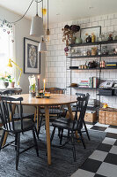 Scandinavian dining room with shelving system and black and white tiled floor