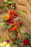 Autumn bouquet of chrysanthemums, rowan berries, strawflowers and snapdragons