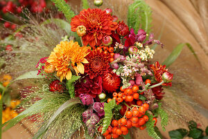 Autumn bouquet of chrysanthemums, rowan berries, strawflowers and snapdragons