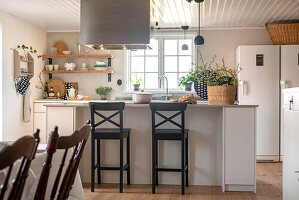 Bright country-style kitchen with bar stools