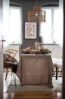 Dining area with linen tablecloth and pendant light