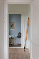 View through open door to bedroom with light blue wall