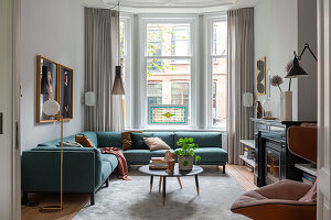 Living room with turquoise sofa and modern design elements