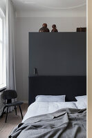 Modernes Schlafzimmer mit dunkelgrauer Akzentwand und hellem Holzfußboden