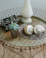 Metal table with shells, succulents and boxes in British country style