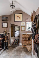 Country-style hallway with riding accessories and decorative baskets