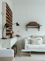 White living room with rustic wooden furniture and shelves