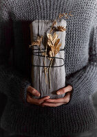Gift wrapped in linen cloth with dried flowers and string