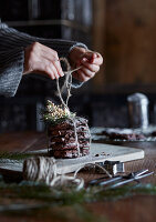 Chocolate cookies decorated for Christmas with fir branches and parcel string