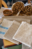 Linen cloths next to flax on a wooden table