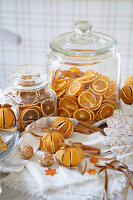 Dried orange slices in glass containers, dried oranges and cinnamon sticks