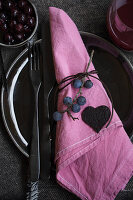 Sloe berries as table decoration and heart made from sloe fruit leather