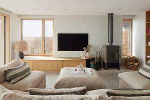 Modern living room with fireplace and wooden elements in a beach house