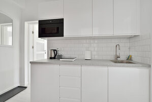 Modern kitchen in white with subway tiles