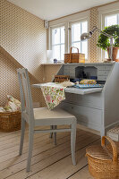 Grey secretary in room with patterned wallpaper and wooden floor