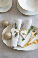 Golden cake forks and Christmas table decorations with heart pendants and glitter baubles