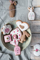 Plate with Easter cookies on a wooden table