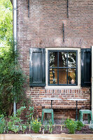 Herb garden in front of brick house