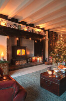 Living room decorated for Christmas with cosy fireplace area
