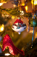 Christmas decorations on the tree with red glitter pumps and painted Christmas tree baubles