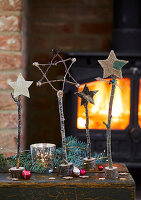 Homemade Christmas decor made from twigs in front of a log fire