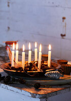 Christmas decorations with candles and cones on a rustic table
