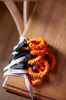 Fabric ribbons with dried orange peel on a wooden table