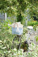Bicycle with blue basket in the summer garden