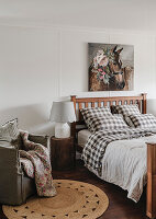 Bedroom with chequered bed linen and horse picture on the wall