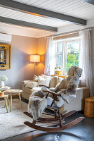 Cosy living room with rocking chair and wooden beamed ceiling