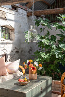 Garden shed with bouquet of flowers and fig tree