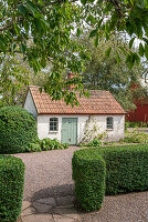 Garden shed with tiled roof in a rural setting