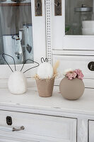 Decorative concrete bunny with metal wire ears on a vintage kitchen buffet